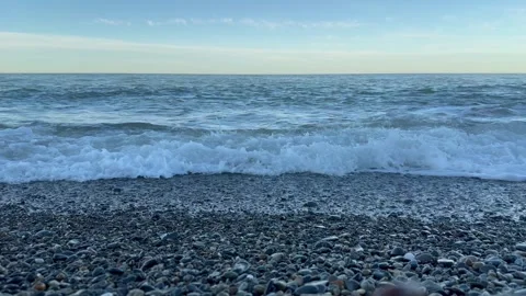 Waves crashing on rocky beach at sunset in coastal paradise Stock Footage 291593866