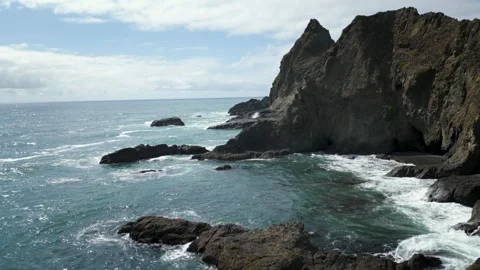 Waves crashing onto rocky cliffs Stock Footage 270895713