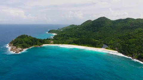 Waves crashing on rocky formations in turquoise waters. Seychelles, Mahe. Stock Footage 311033294