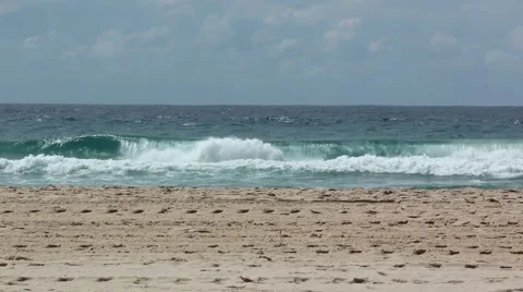 Waves crashing on a sandy beach Stock Footage 55250176