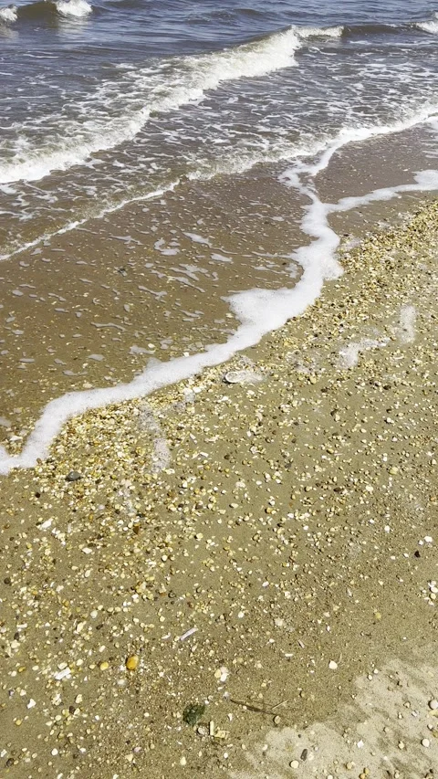 Waves Crashing On a Sandy Beach With Pebbles, Vertical Video Nature Background Stock Footage 308331023