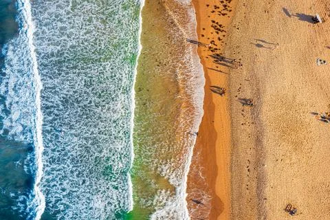 Waves crashing on the sandy beach Stock Photos
