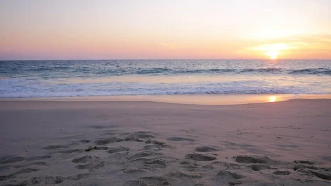 Waves crashing on a sandy beach at sunset - Scarborough Beach, Perth - Australia Stock Footage 107911918