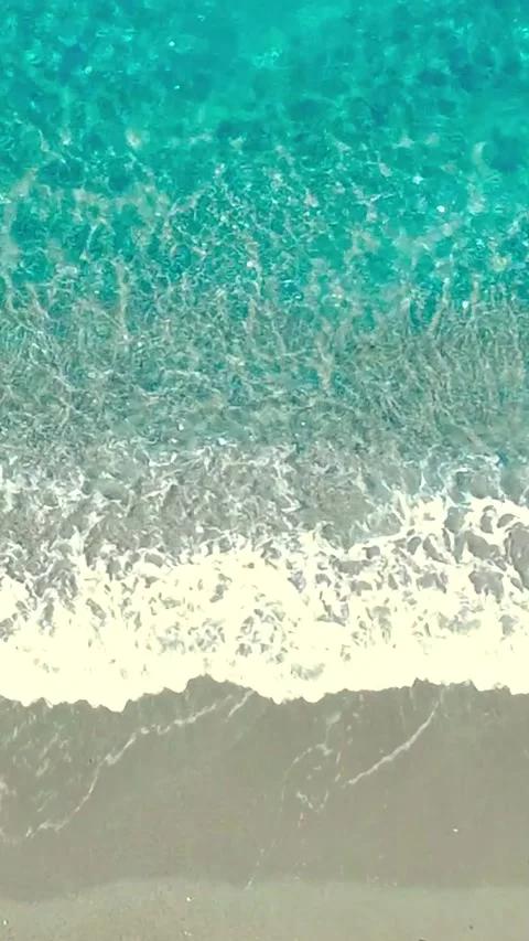 Waves Crashing on a Sandy Beach Under a Clear Blue Sky in a Tropical Paradise Stock Footage 318218710