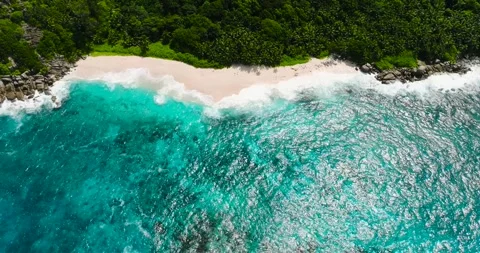 Waves crashing on a secluded sandy beach. Seychelles, Mahe. Stock Footage 311881655