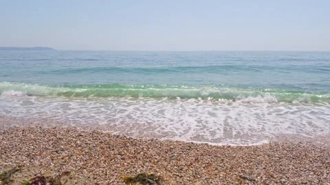 Waves Crashing On Shingle Beach Under Bright Blue Sky At Charlestown Coast Stock Footage 337490561