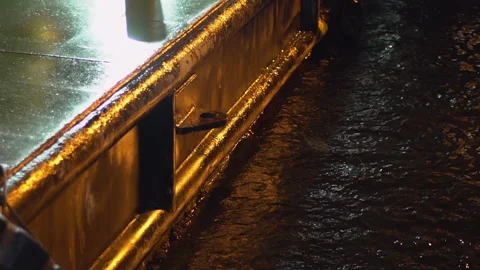 Waves crashing into a ship pier built by barges at night. Stock Footage 144335162