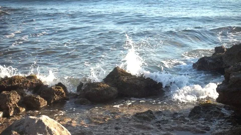 Waves crashing in slow motion against the rock Stock Footage 124472080
