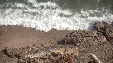 Waves crashing in slow motion against the rock Stock Footage 124694612