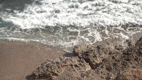 Waves crashing in slow motion against the rock Stock Footage 124694864