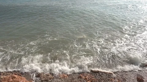 Waves crashing in slow motion against the rock Stock Footage 124695992