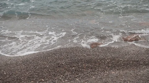 Waves crashing in slow motion against the rock Stock Footage 125096549
