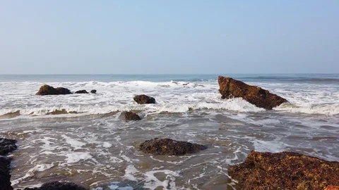 Waves crashing on stone beach Stock Footage 128841716