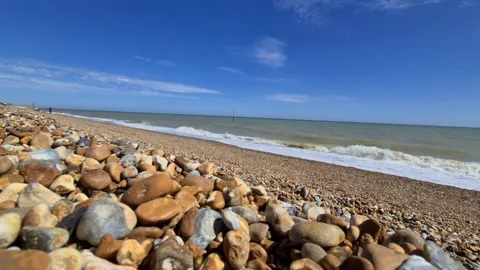 Waves crashing onto a stone beach Stock Footage 144322401
