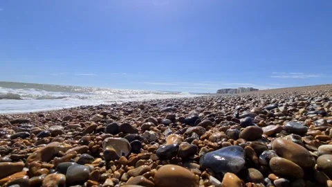 Waves crashing onto a stone beach 動画素材 144322412