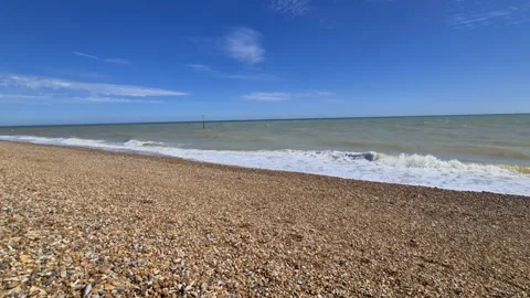 Waves crashing onto a stone beach Stock Footage 144322419