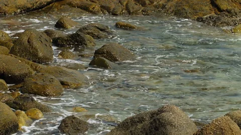 Waves crashing on stone beach Stock Footage 155754896