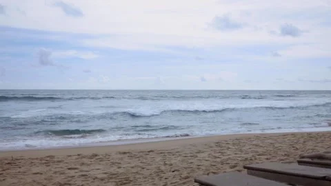 Waves crashing on sunny sandy beach with sun beds 5OFPS Stock Footage 287207570