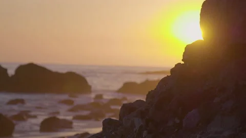 Waves crashing at sunset with sun flare, Thousand Step Beach Stock Footage 174863103