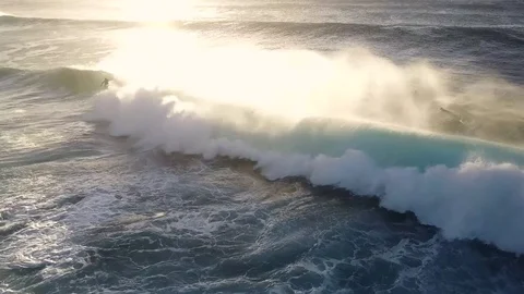 Waves Crashing At Sunset With Surfers In The Background Video stock 78076086