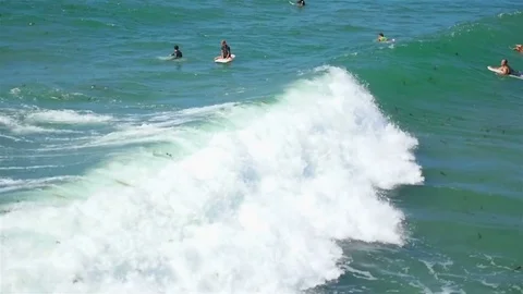 Waves crashing surfers Stock Footage 75767135