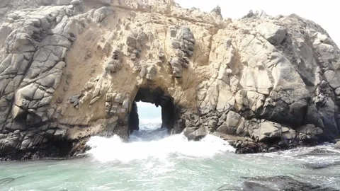 Waves Crashing Through Rock Formation at California Beach, Aerial View Stock Footage 142307878