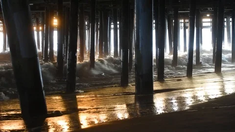 Waves crashing under pier Stock Footage 106598894