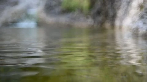 Waves created by a small waterfall that flows into a pool (slow motion) Stock-Footage 212735612