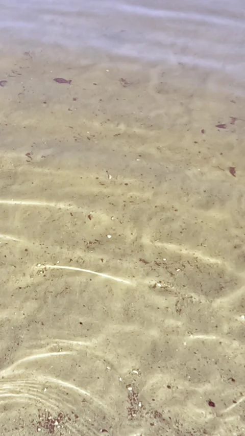 Waves creating patterns on shallow sandy seabed Stock Footage 317162185