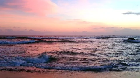 Waves crushing during the purple sunset Stock Footage 119557095