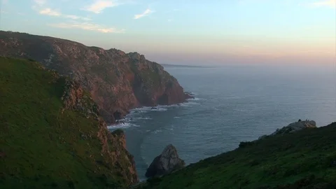 Waves crushing by ocean cliff hills, beautiful sunset on cape Roca, Portugal Stock Footage 73544393