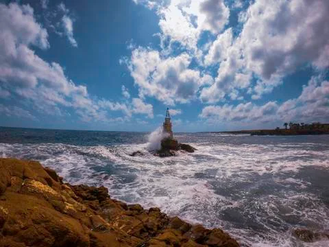 Waves crushing over a lighthouse in Black Sea Bulgaria Stock Photos