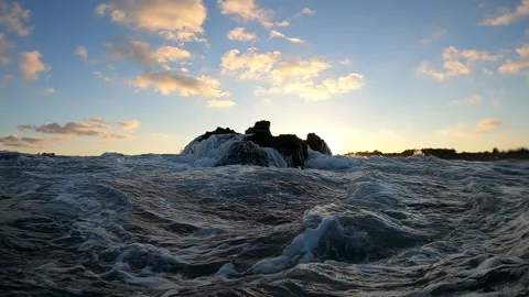Waves crushing over rocks at sunset Stock Footage 148515025