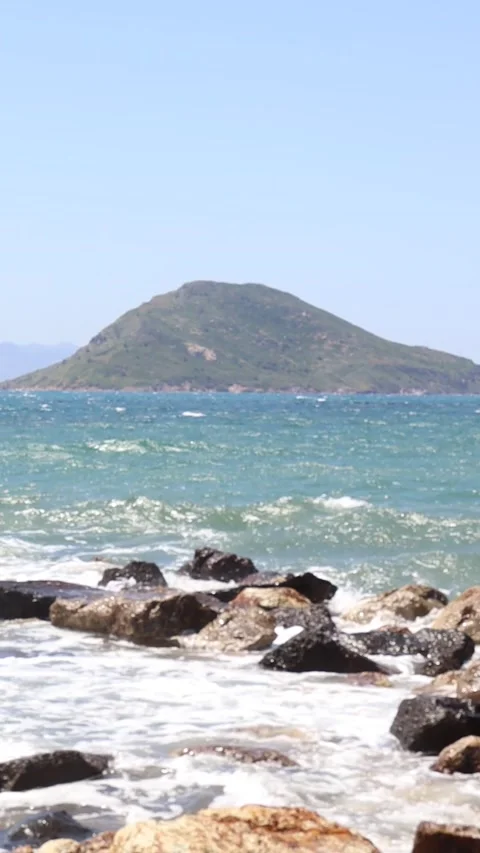 Waves Crushing to the Rocks with Çatalada in the Background (Vertical) Stock Footage 236659097