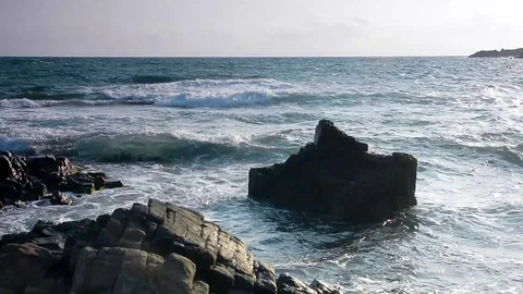 Waves crushing rocks on the coast Stock Footage 123658623