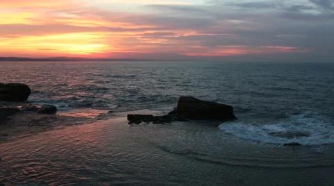 Waves crushing the rocks in dramatic sunset scene Stock Footage 57385764