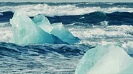 Waves Crushing Through Icebergs At Black Beach Stock Footage