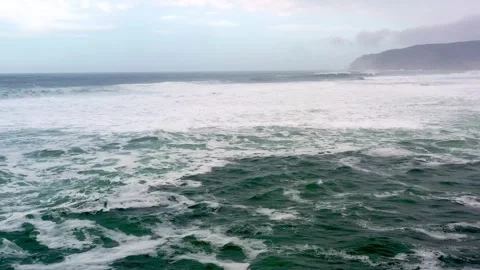 Waves Dance Under a Cloudy Sky at the Coast During an Enchanting Afternoon Stock Footage 344745089