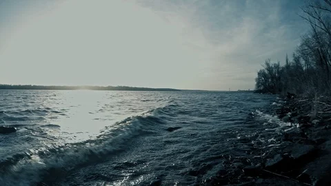 Waves of the dark blue river illuminated by bright daylight Stock Footage 125611434