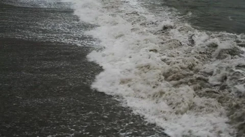 Waves in the dark sea breaking on the shore with the formation of spray. Stock Footage 62890582