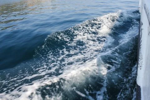 Waves diverging from the ship. Stock Photos