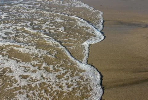 Waves draw different forms just before dying in the coast Stock Photos