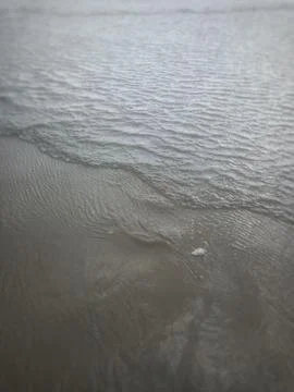 Waves drawing the sands Stock Photos