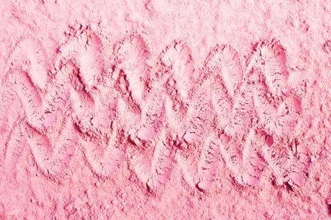 Waves drawn on pink powder Stock Photos