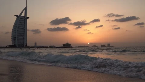 Waves on Dubai Beach During Sunset Slow Motion Burj Al Arab in the background Stock Footage