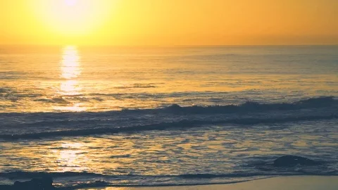 Waves during deep yellow sunset with water reflections, Carcavelos beach, Por Stock Footage 108923260