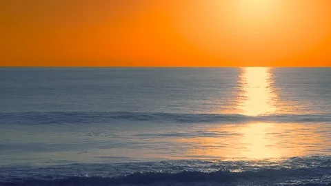 Waves during deep yellow sunset with water reflections, Carcavelos beach, Por Stock Footage 108939036