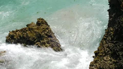 Waves during high tide wash around a rock Stock Footage 143202665