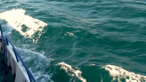Waves of emerald color are broken on bow of pleasure boat and foamed. Stock Footage 106232249
