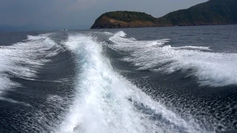 Waves from the engines of a high-speed boat. Rear view. Blue sky, white cloud Video stock 109194976